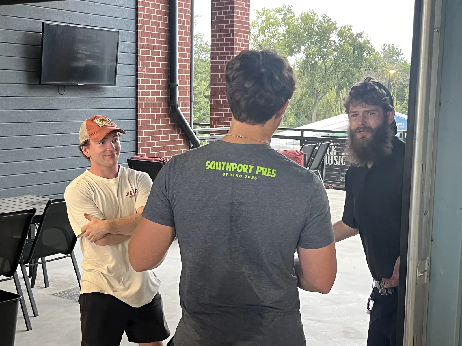 Three local professionals engaged in conversation during the networking event